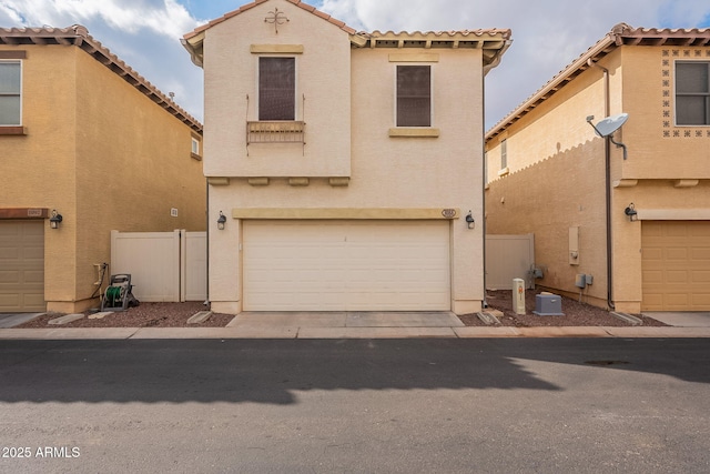 mediterranean / spanish house with a garage