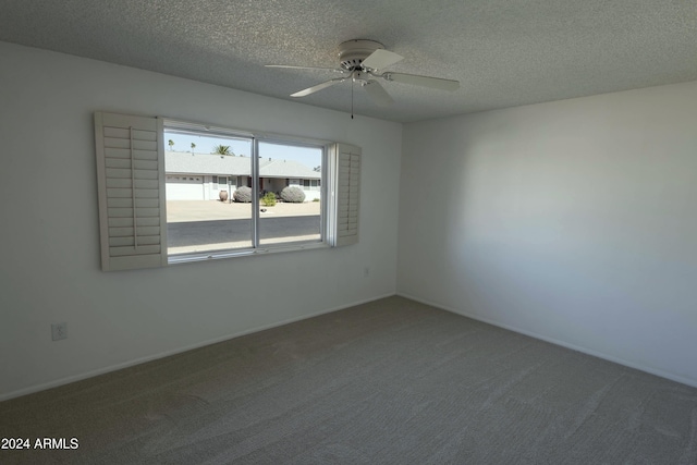 empty room with a textured ceiling, carpet floors, and ceiling fan