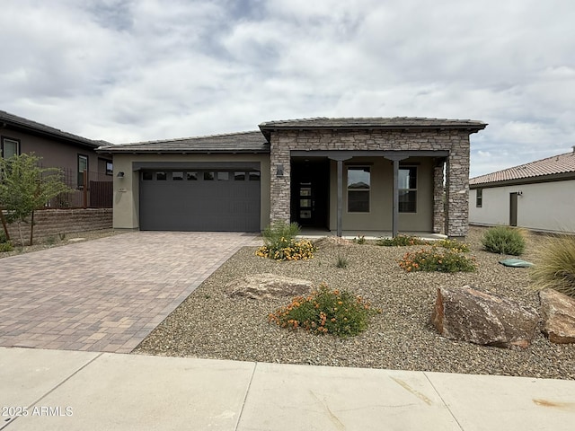 4081 Fence Post Way, Wickenburg, AZ 85390 - view of front of property with stucco siding, stone siding, an attached garage, and decorative driveway