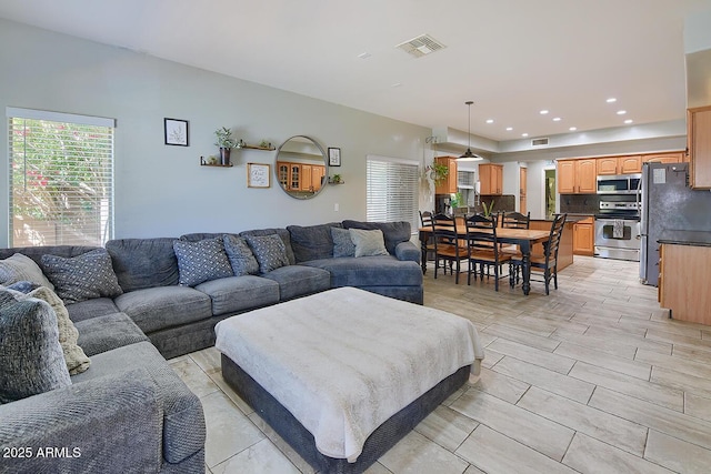 living room featuring visible vents and recessed lighting