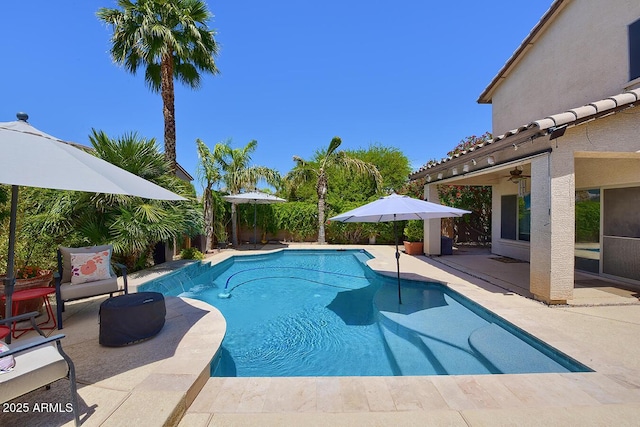 view of pool with a fenced in pool, ceiling fan, and a patio area