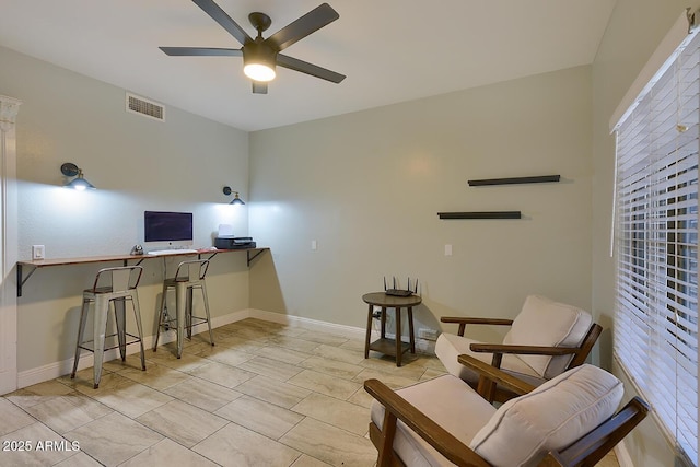 interior space featuring visible vents, baseboards, and ceiling fan