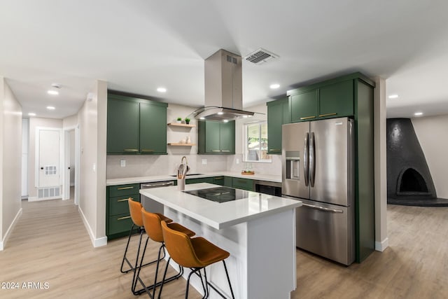 kitchen featuring black electric cooktop, island exhaust hood, stainless steel fridge with ice dispenser, and green cabinetry