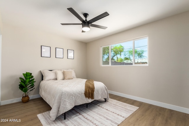 bedroom featuring wood-type flooring and ceiling fan