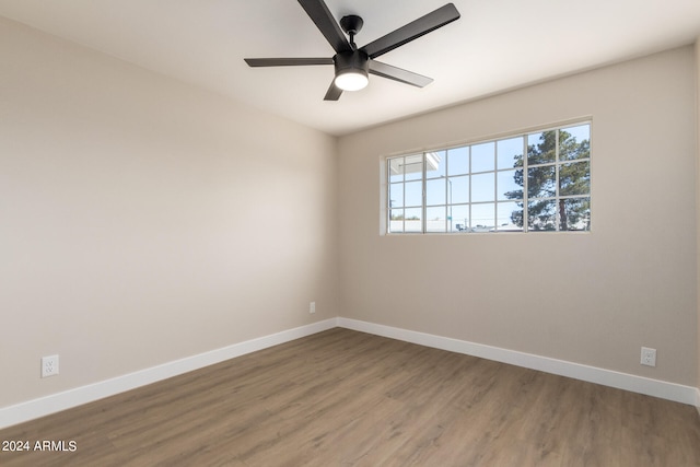 empty room with hardwood / wood-style floors and ceiling fan