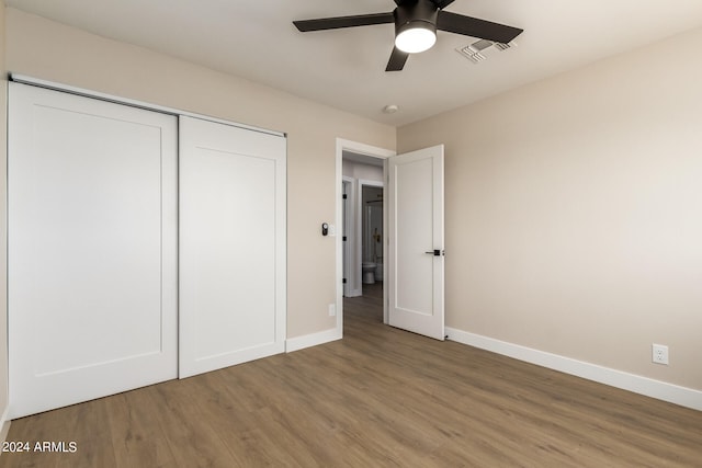 unfurnished bedroom with hardwood / wood-style floors, a closet, and ceiling fan