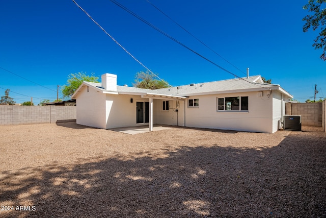 rear view of property featuring a patio and central AC