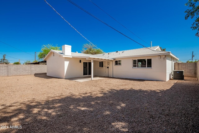 7508 E Beatrice St, Scottsdale, AZ 85257 - back of house featuring a fenced backyard, a chimney, a patio area, and central AC