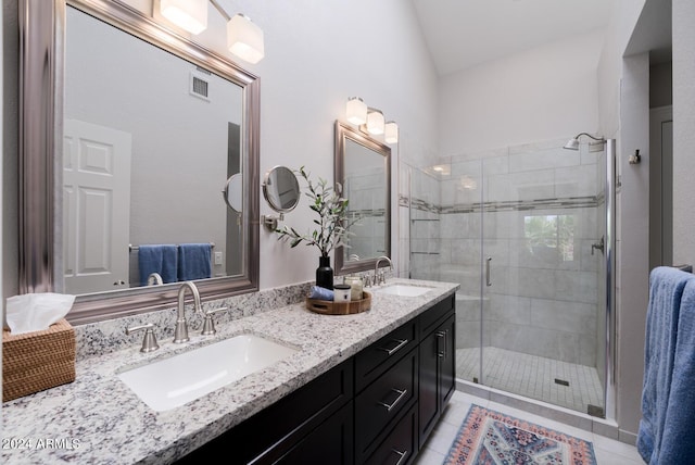 bathroom with tile patterned floors, vanity, and an enclosed shower