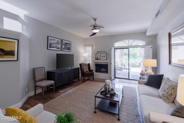 living room with ceiling fan and dark hardwood / wood-style flooring