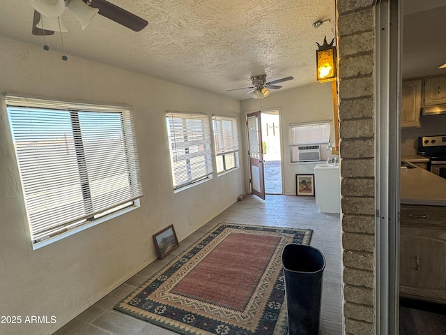 hallway featuring cooling unit, a textured ceiling, and tile patterned floors