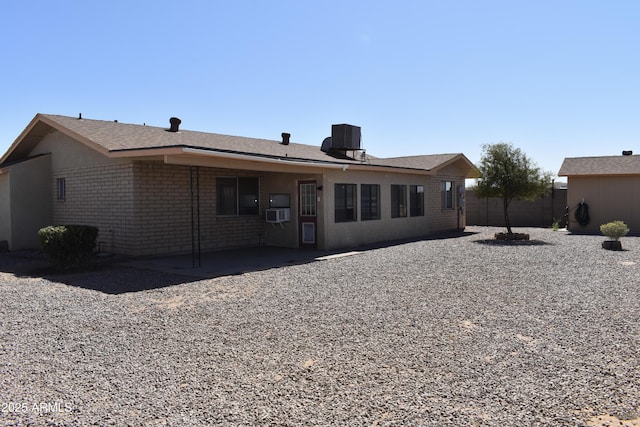 back of house with a patio area, brick siding, cooling unit, and fence