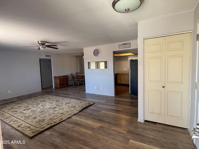 living area with ceiling fan, visible vents, and dark wood-style flooring