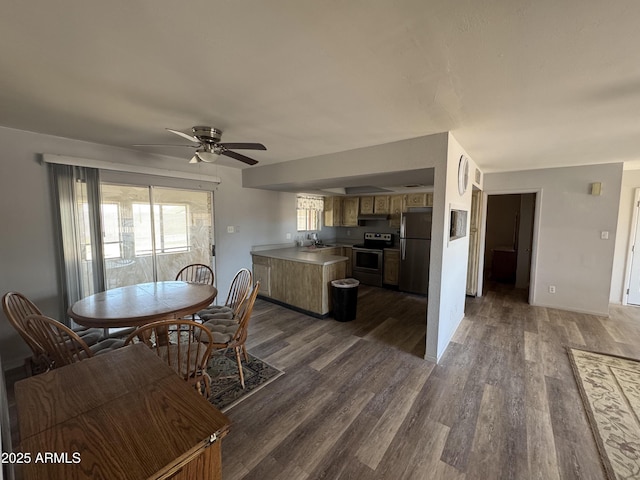 dining room with a ceiling fan and dark wood finished floors