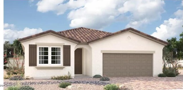 11408 S 50th Ln, Laveen, AZ 85339 - mediterranean / spanish-style house with stucco siding, a garage, decorative driveway, and a tile roof