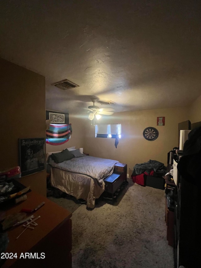 bedroom featuring ceiling fan and carpet