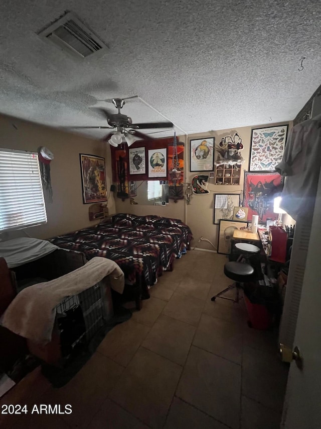 bedroom with a textured ceiling and ceiling fan