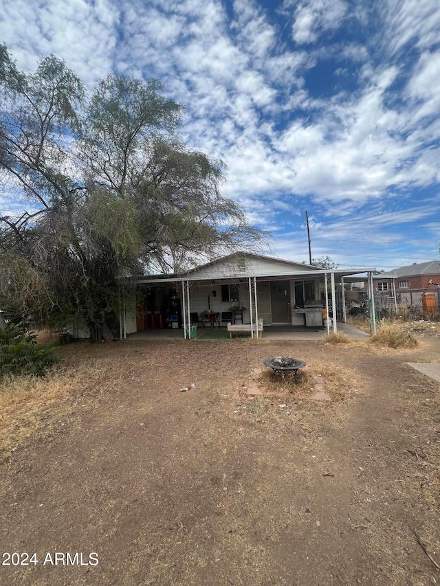 view of front of home featuring a patio area and an outdoor fire pit