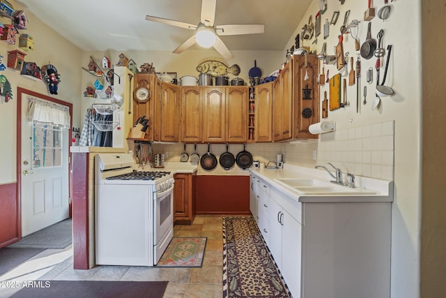 583 Reata Pass, Happy Jack, AZ 86024 - kitchen with a sink, tasteful backsplash, light countertops, and white gas range
