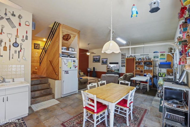 583 Reata Pass, Happy Jack, AZ 86024 - dining space featuring stone finish floor, stairs, and ceiling fan