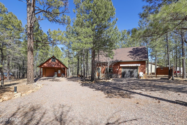 583 Reata Pass, Happy Jack, AZ 86024 - chalet / cabin featuring a detached garage, an outbuilding, and gravel driveway