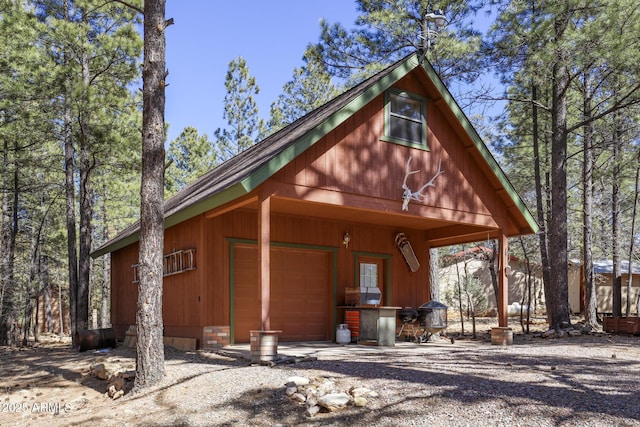 583 Reata Pass, Happy Jack, AZ 86024 - view of front of home with an attached garage and an outbuilding