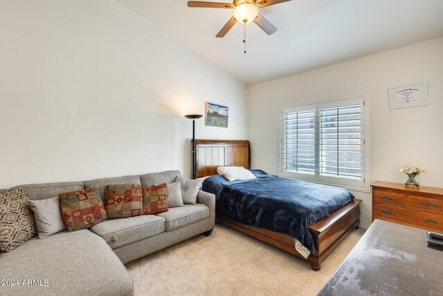 bedroom featuring lofted ceiling, ceiling fan, and light colored carpet