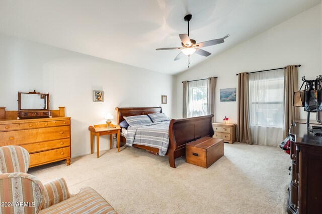 bedroom with lofted ceiling, ceiling fan, and light carpet