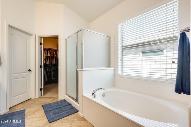 bathroom with a wealth of natural light, shower with separate bathtub, and tile patterned flooring