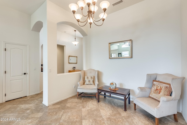 sitting room with high vaulted ceiling and a notable chandelier