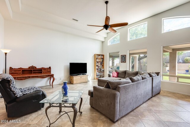 tiled living room with ceiling fan