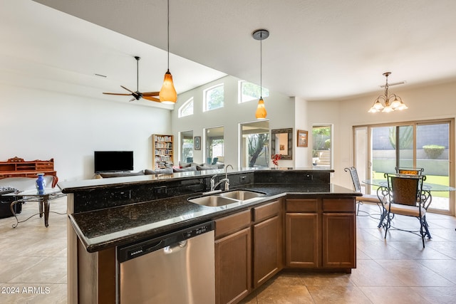 kitchen featuring vaulted ceiling, a center island with sink, stainless steel dishwasher, hanging light fixtures, and sink