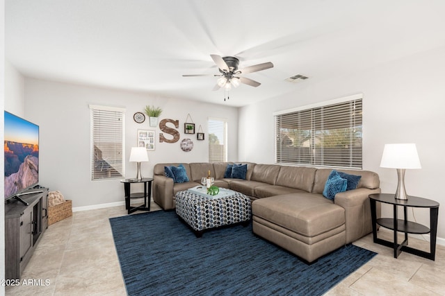 tiled living room featuring ceiling fan