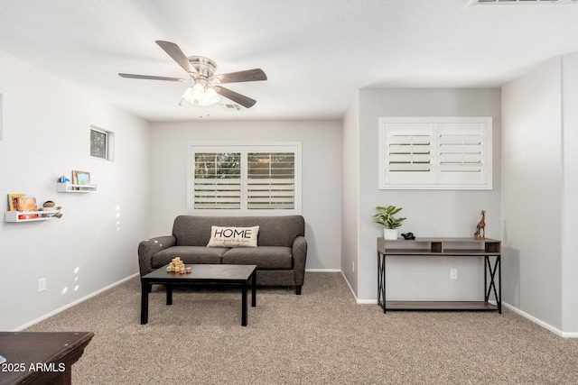 living room with ceiling fan and carpet floors