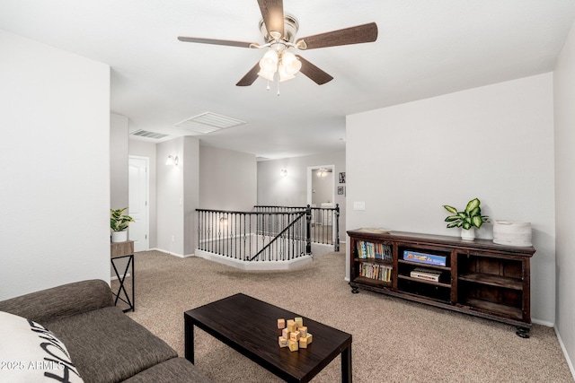 living room featuring carpet and ceiling fan