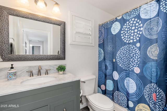 bathroom featuring vanity and toilet