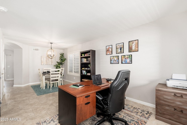 office space featuring a chandelier