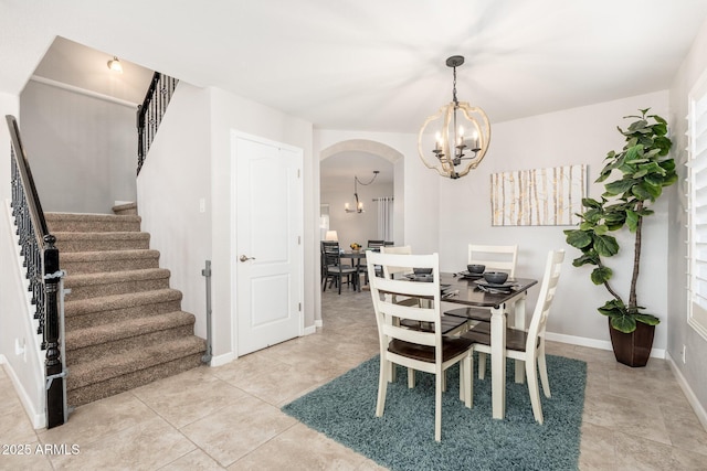 tiled dining space with a chandelier