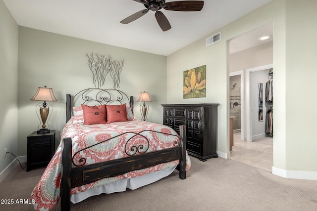 bedroom with light carpet, ceiling fan, visible vents, and baseboards