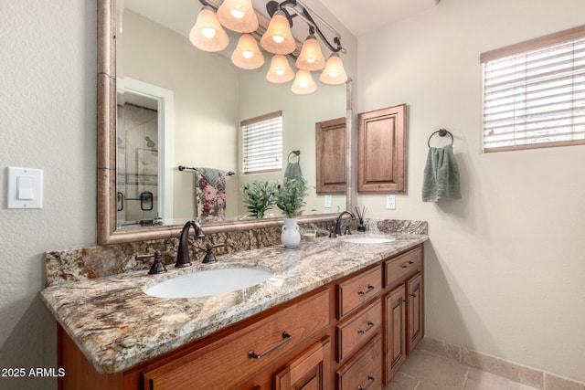 full bathroom with double vanity, baseboards, and a sink