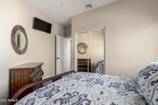 bedroom featuring visible vents and a closet