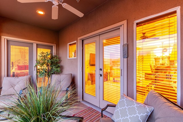 doorway to property featuring stucco siding, ceiling fan, and french doors