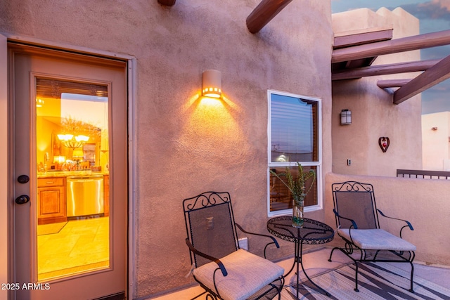 exterior space featuring a ceiling fan and stucco siding