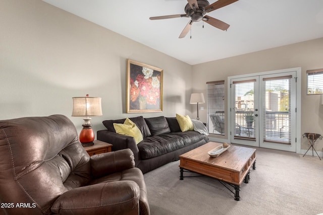 living room featuring french doors, carpet flooring, and a ceiling fan