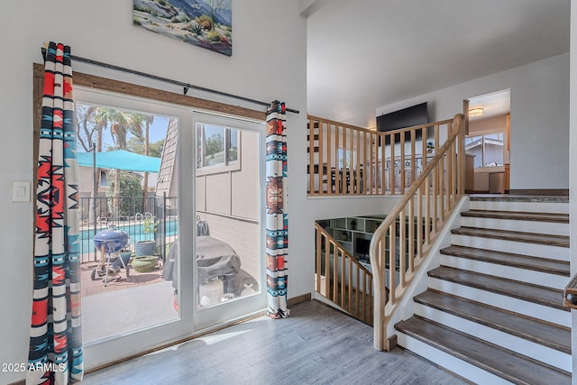 staircase featuring wood finished floors and baseboards