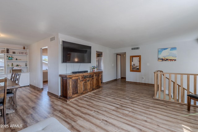 living room featuring light wood finished floors and baseboards