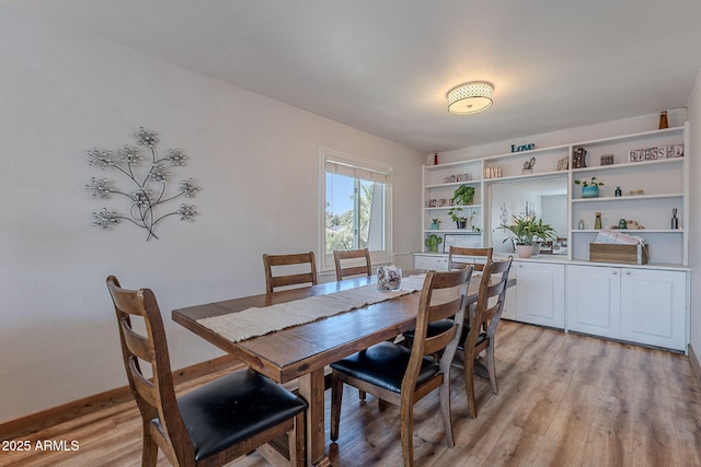 dining space featuring light wood-style floors
