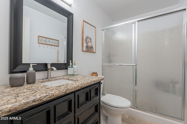 full bathroom with a stall shower, toilet, and vanity