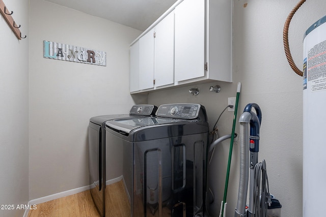 laundry area with separate washer and dryer, cabinet space, light wood-style flooring, and baseboards
