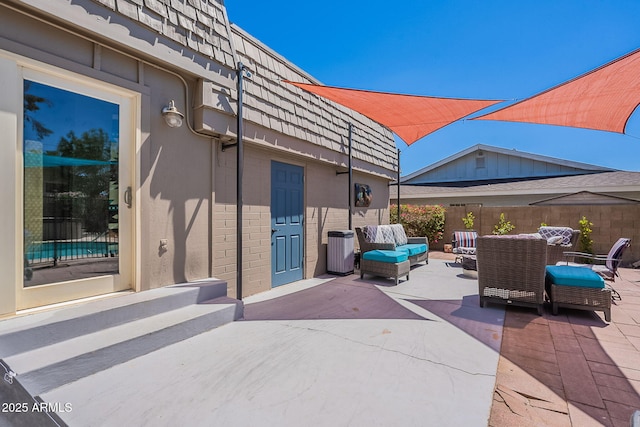 view of patio / terrace featuring an outdoor hangout area and fence